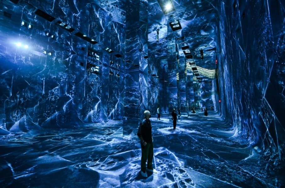Attendees interact with immersive visualizations from the inaugural exhibition Machine Dreams: Rainforest are projected at DATALAND, the Museum of AI Arts