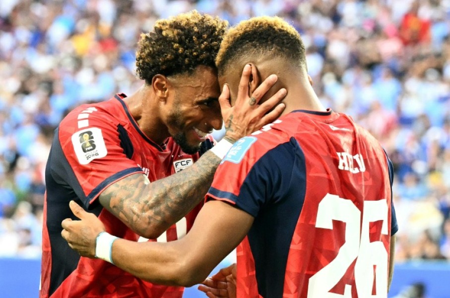 Cape Verde's forward Helio Varela (26) celebrates with teammate Ryan Mendes after scoring his team's equaliser in a 2-2 draw with Uruguay