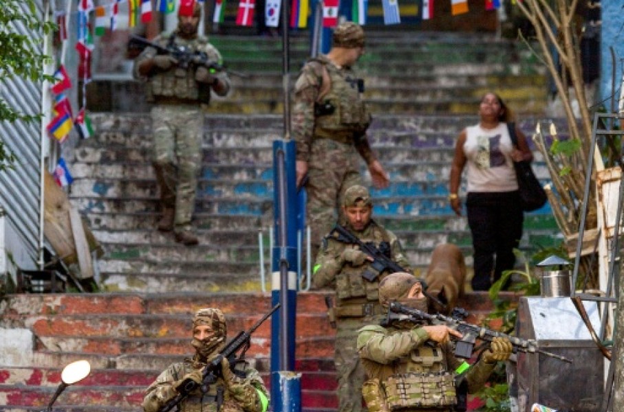 Brazilian special police forces patrol a street during an operation in the Santa Marta favela