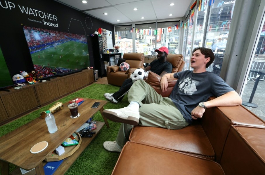 Austin Franklin (right) and Kevin Akoto have a dream job: Getting paid to watch all 104 games of the World Cup in a cube-like studio in the heart of New York's Times Square