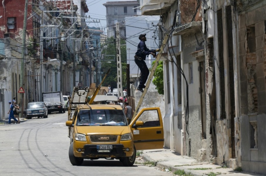 An electrician works on the power grid in Havana during a nationwide power outage in Cuba, the third in six months