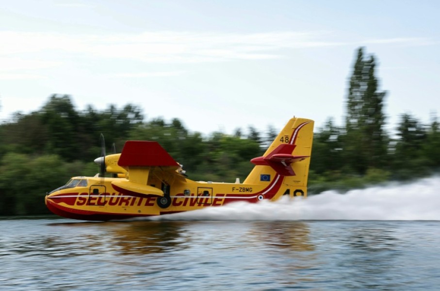 A firefighting plane scooped up water from the Seine river to douse the fire in Fontainebleau forest southeast of Paris