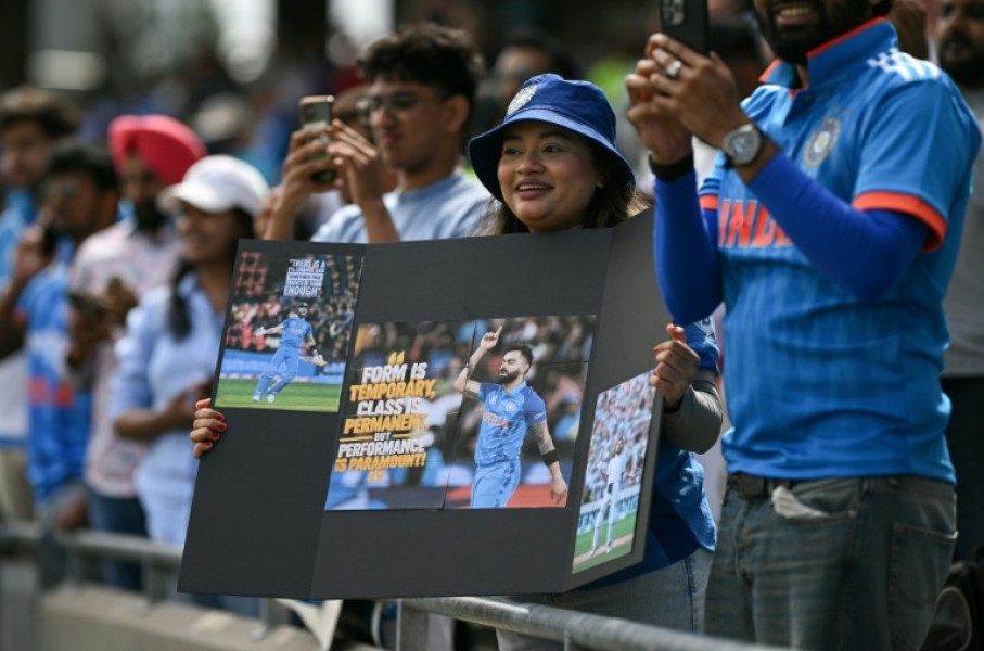 India fans watch as the team take to the field before the start of the first one-day international (ODI) cricket match against England at Edgbaston in Birmingham, central England