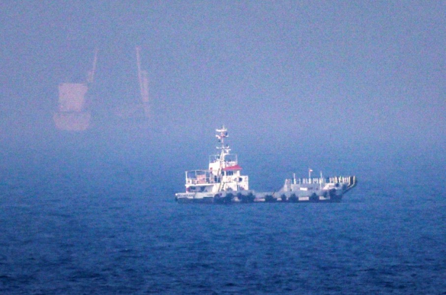 Ships sail near the Strait of Hormuz off the eastern coast of the United Arab Emirates at Khor Fakkan on July 13, 2026