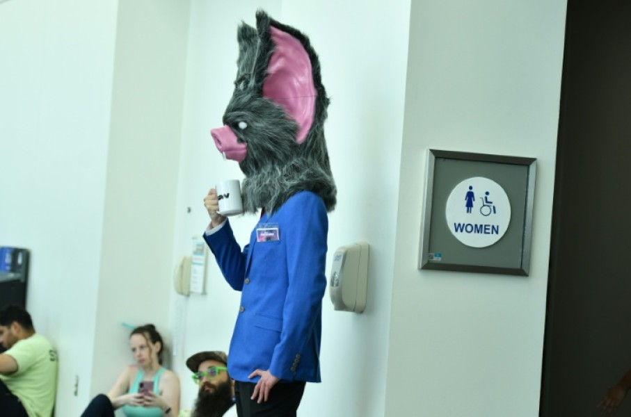 A cosplayer waits by the restrooms during Comic Con International in San Diego