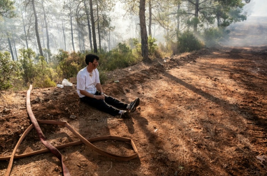 A volunteer rests amid operations to tackle a wildfire in Fethiye, southwest Turkey