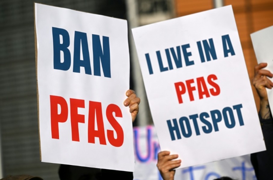 Environmental activists hold placards during a demonstration against PFAS chemicals next to the EU Commission headquarters in Brussels in March 2026