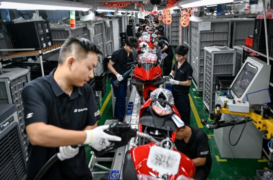 Workers assemble motorcycles at the ZXMoto factory in Chongqing, southwestern China