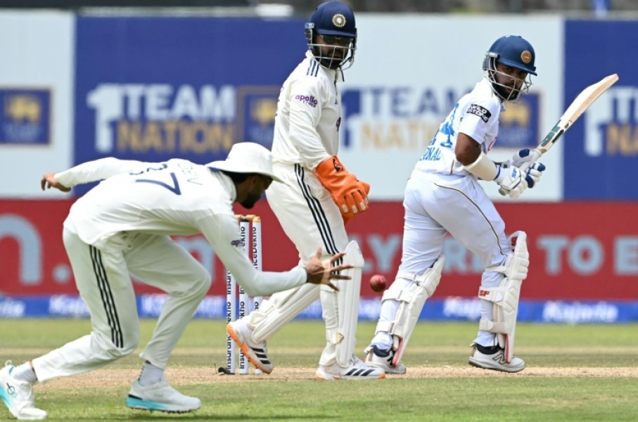 Sri Lanka's Sonal Dinusha (R) watches the ball after playing a shot during the third day of the first Test