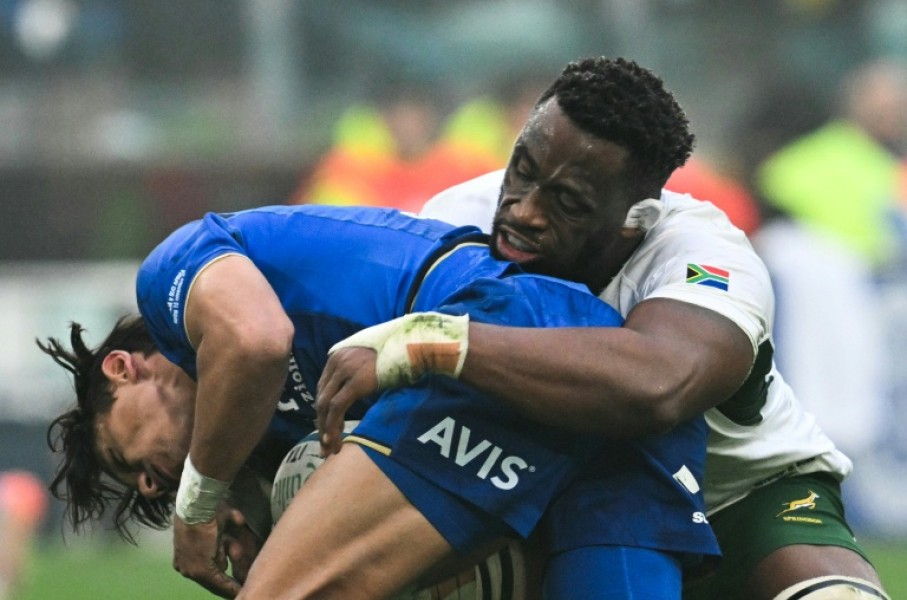 South Africa captain Siya Kolisi (R) makes a tackle during a tour victory over Italy last November.