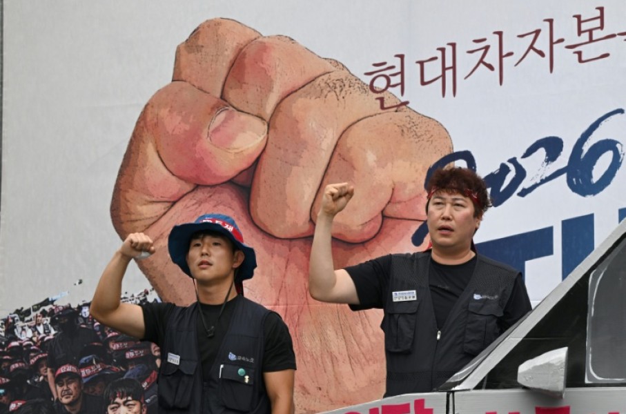 Members of the Korean Metal Workers' Union shout slogans during a joint strike rally in front of the Hyundai Motor headquarters in Seoul on August 21, 2026.