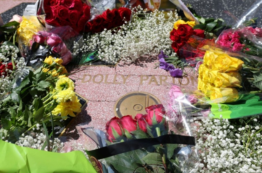 Flowers are seen on the Hollywood Walk of Fame Star of late US singer-songwriter Dolly Parton in the Hollywood neighborhood of Los Angeles on August 25, 2026.