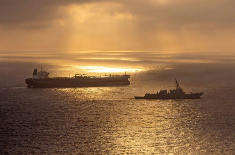 This US Navy handout photo released on May 8 shows the Arleigh Burke-class guided-missile destroyer USS Rafael Peralta (DDG 115) implementing a maritime blockade against the Iran-flagged crude oil tanker vessel Herby