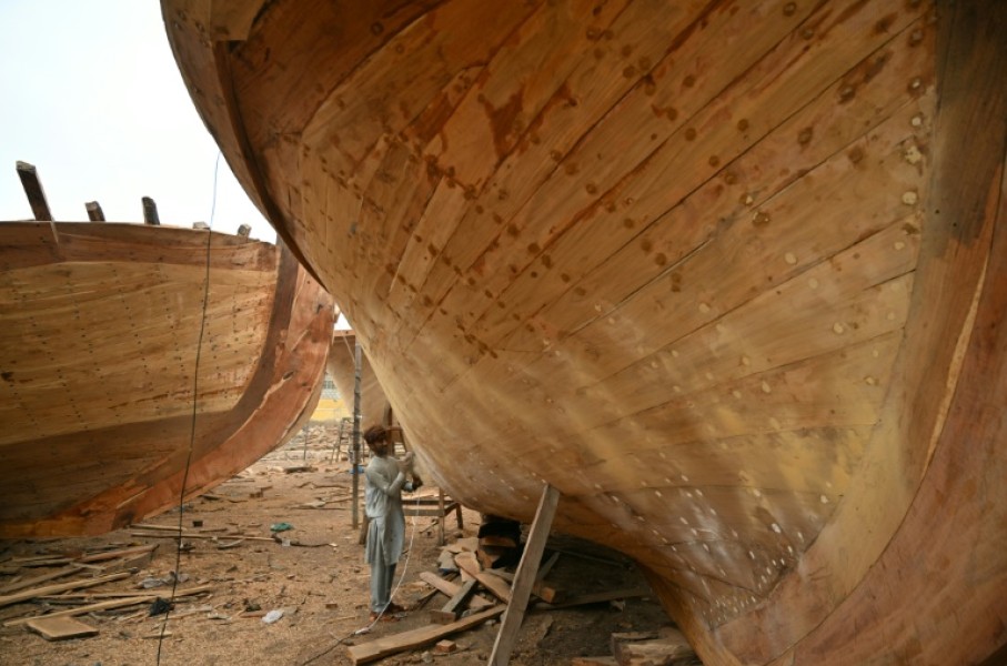 Workers in Ibrahim Hyderi town in Pakistan assemble handcrafted vessels timber by timber, despite the rise of industrial shipbuilding