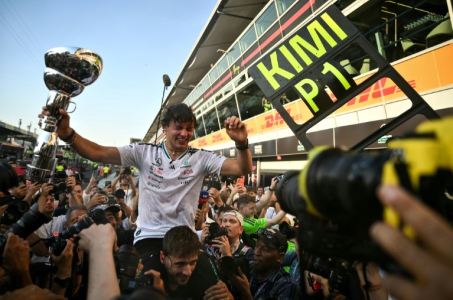 Kimi Antonelli celebrates with with his Mercedes team after coming from 19th on the grid to win the Italian GP