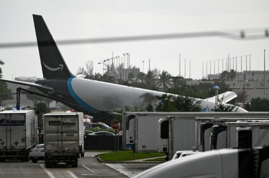 The tail section of a cargo plane is seen at Miami International Airport after it overshot the runway