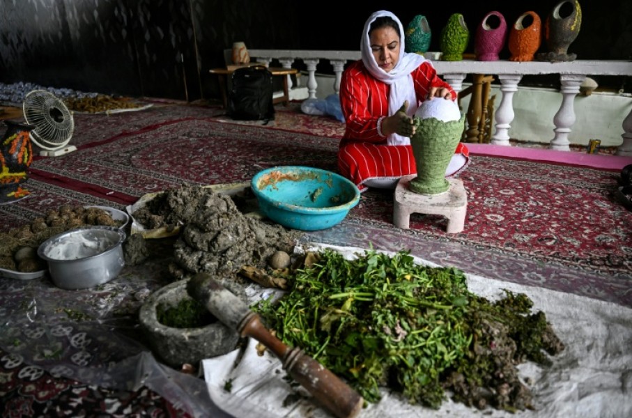 A Kashmiri artisan uses dried aquatic weeds and grass collected from Dal Lake to create sustainable handcrafted papier-mache at a workshop in Srinagar on August 19, 2026