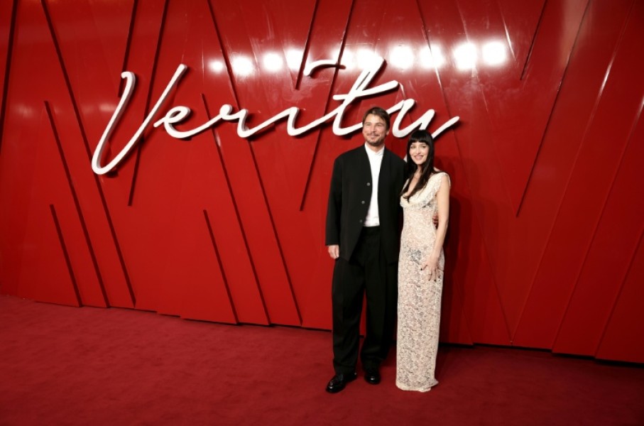 US actors Josh Hartnett and Dakota Johnson pose on the red carpet upon arrival to attend the UK Gala Screening of Verity, at the Curzon Mayfair, in London in September 2025
