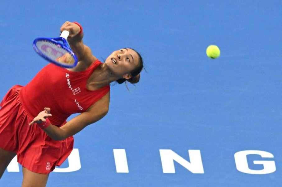 China’s Zheng Qinwen serves to Russia’s Mirra Andreeva