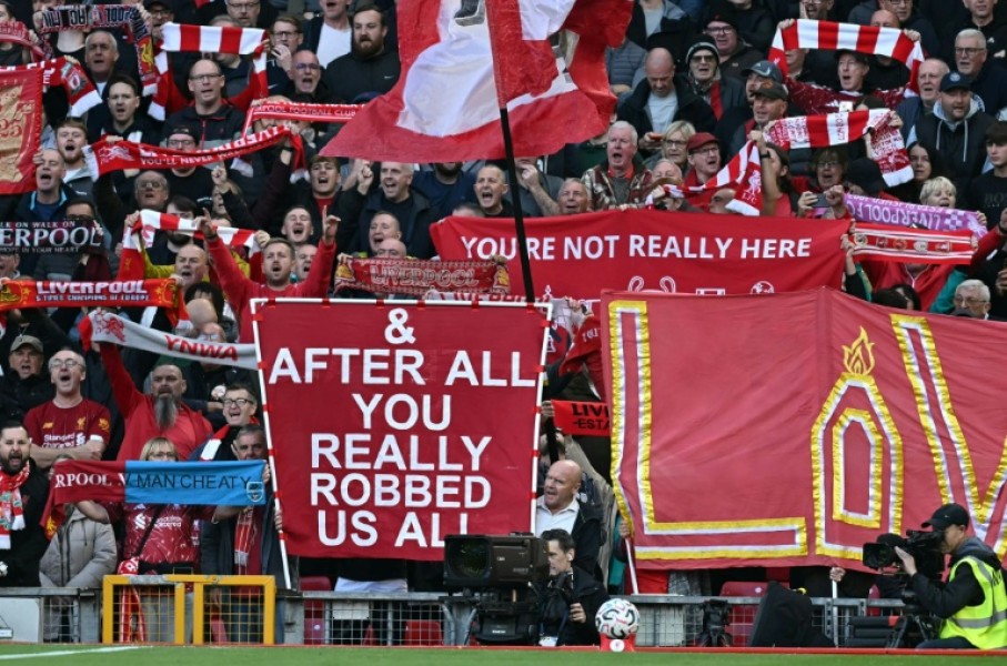 Liverpool fans hold signs mocking Manchester City's financial scandal