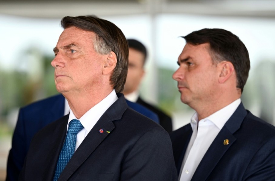 Jair Bolsonaro (L) remains the leader of his political movement in Brazil and selected Flavio Bolsonaro (R) to run for president in his place
