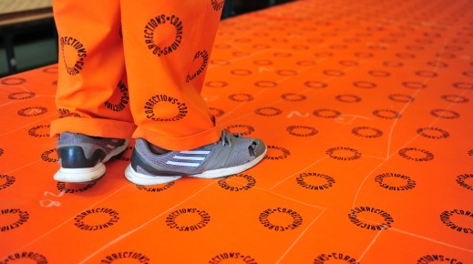 File: A prisoner with Correctional Services printed material. GettyImages/Nigel Jared