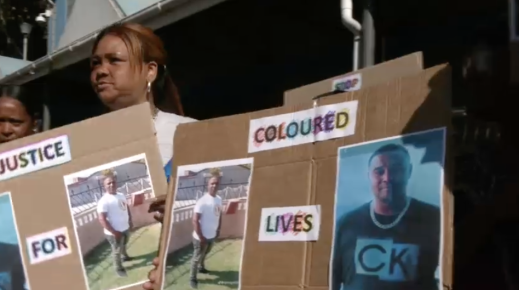 Community members protesting outside court.