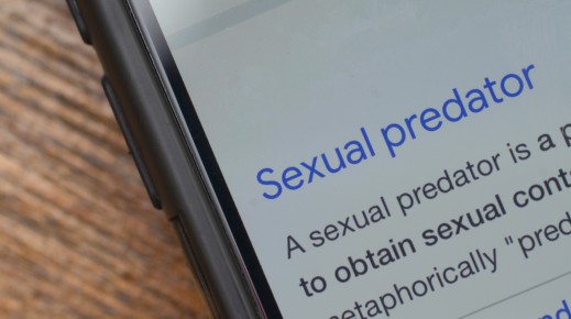 The words 'sexual predator' seen on a phone. GettyImages/Abu Hanifah