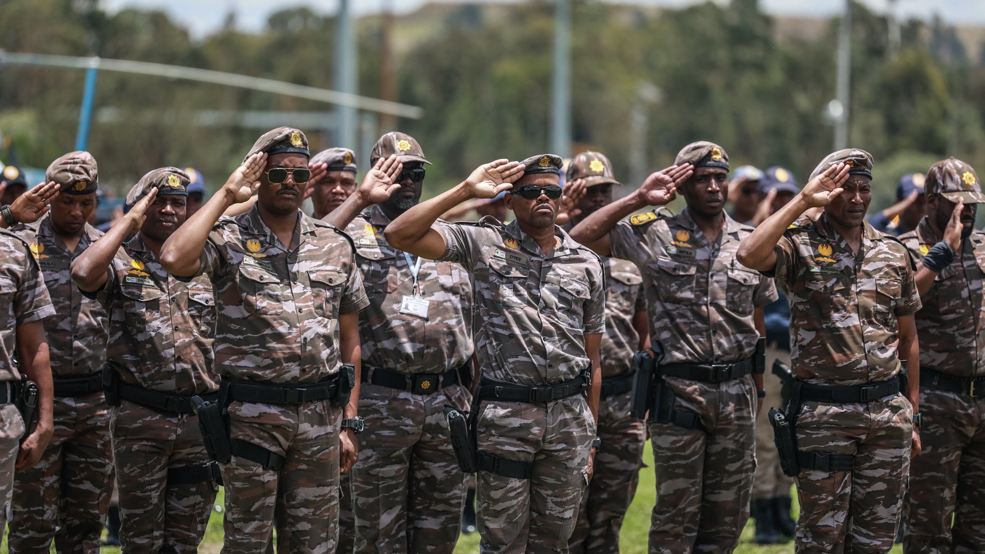 Members of South African Presidential Protection Service salute during the Integrated Law Enforcement parade near the Nasrec Expo Centre in Johannesburg, on November 19, 2025.