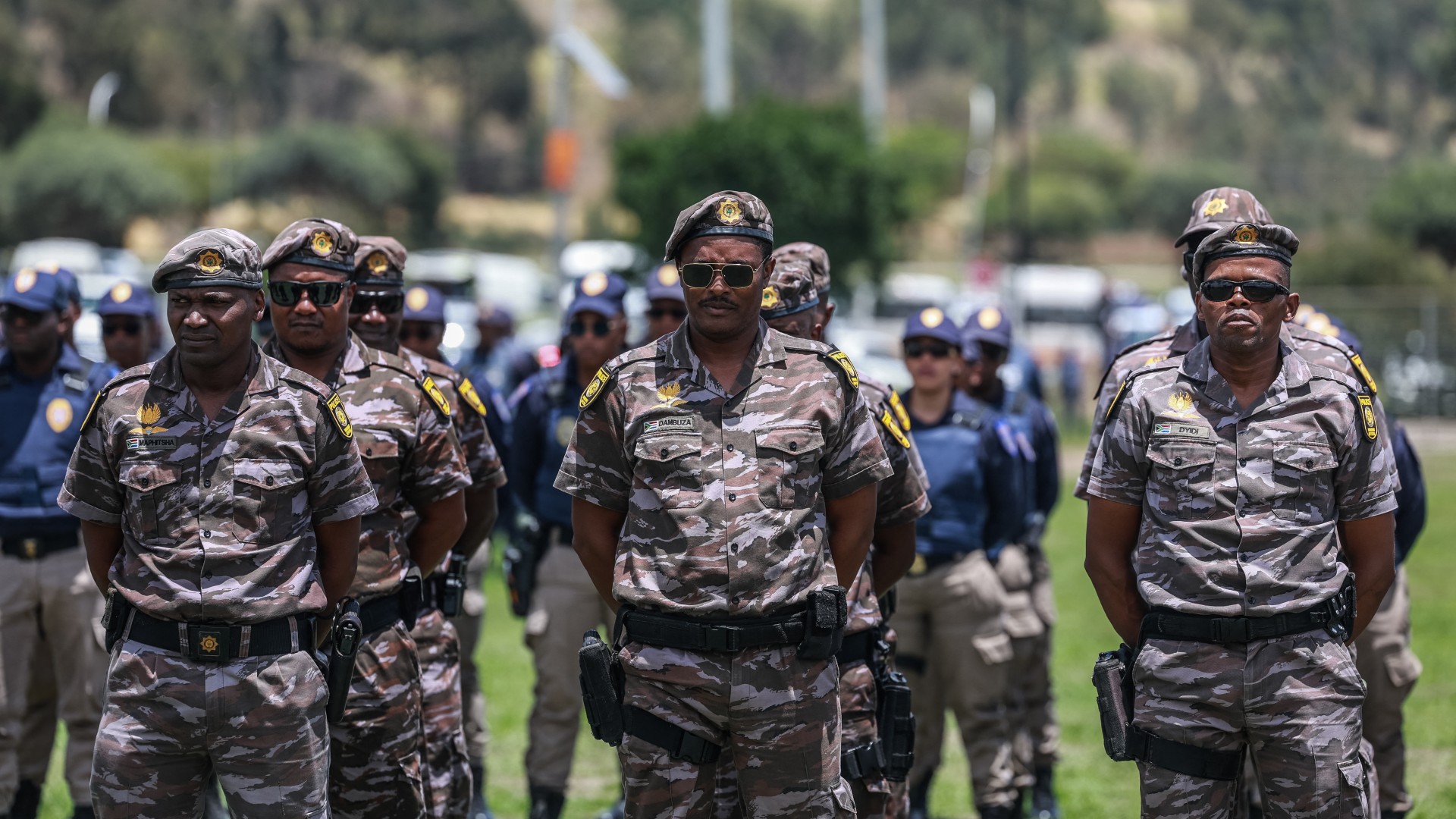 Members of South African Presidential Protection Service stand at attention during the Integrated Law Enforcement parade near the Nasrec Expo Centre in Johannesburg, on November 19, 2025.