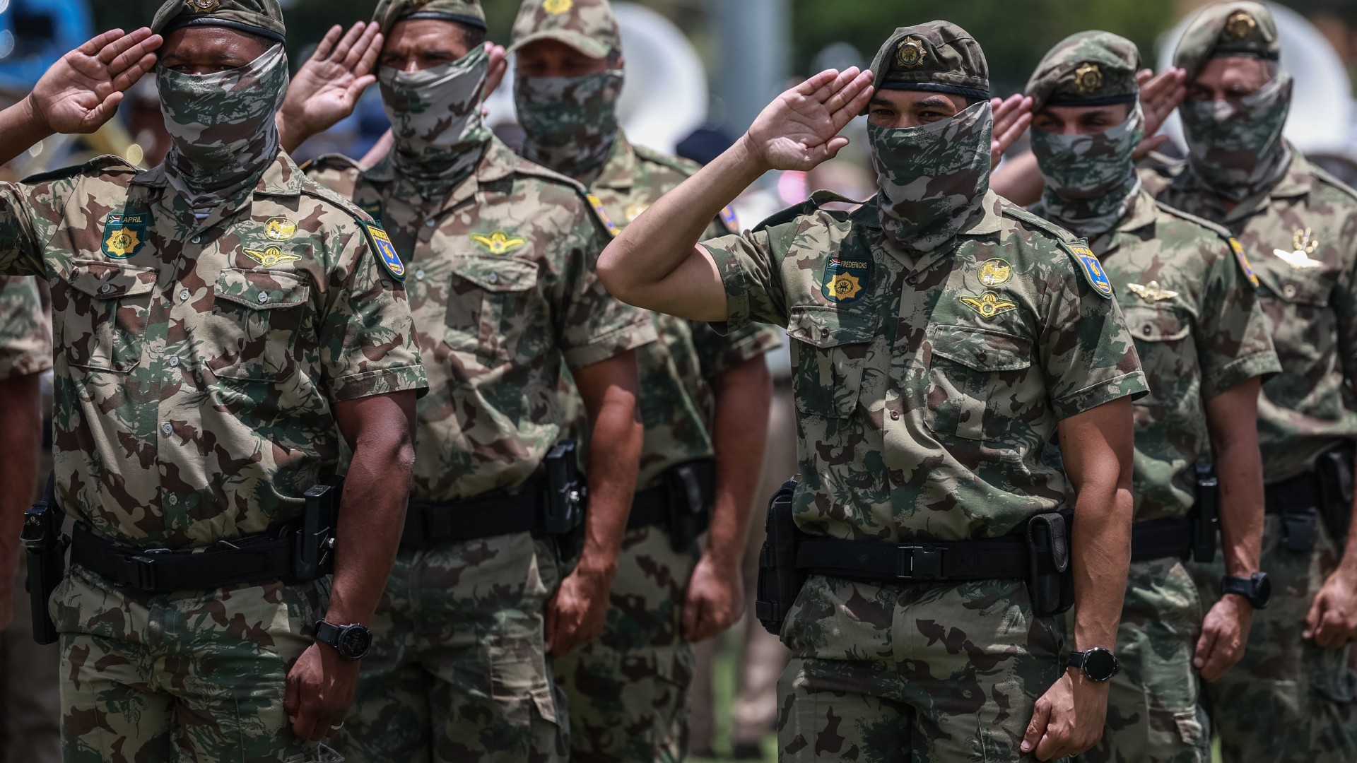 Members of the South African Police Service (SAPS) Special Task Force salute during the Integrated Law Enforcement parade near the Nasrec Expo Centre in Johannesburg, on November 19, 2025.