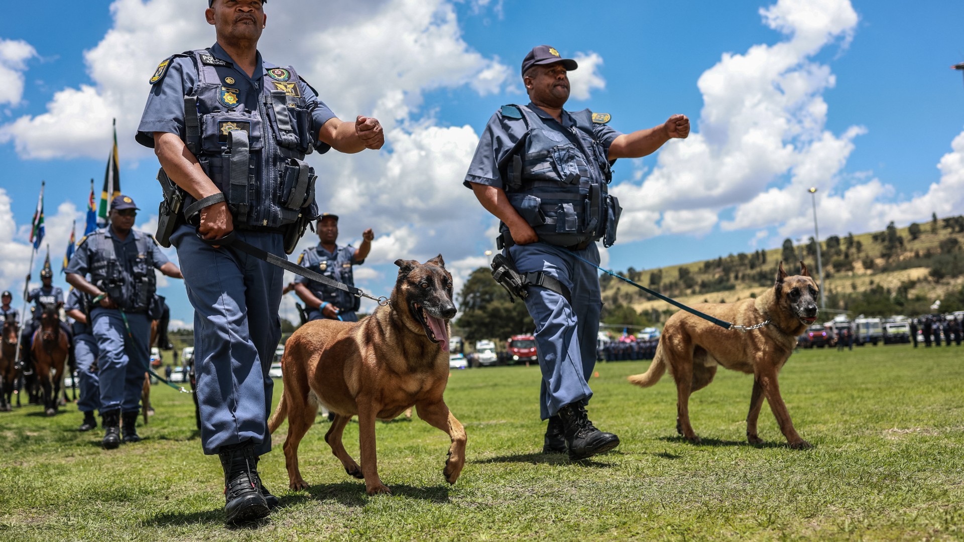 Members of the South African Police Service (SAPS) K-9 Unit march during the Integrated Law Enforcement parade near the Nasrec Expo Centre in Johannesburg, on November 19, 2025.