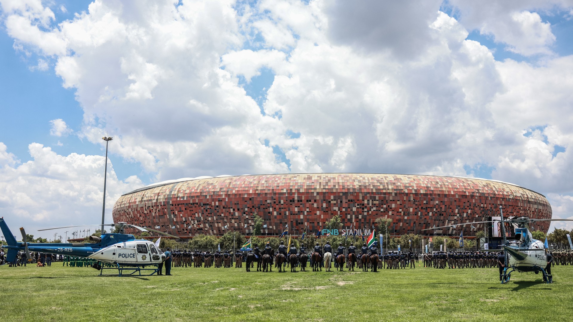 Members of the South African Police Service (SAPS) stand at attention during the Integrated Law Enforcement parade near the Nasrec Expo Centre in Johannesburg, on November 19, 2025.