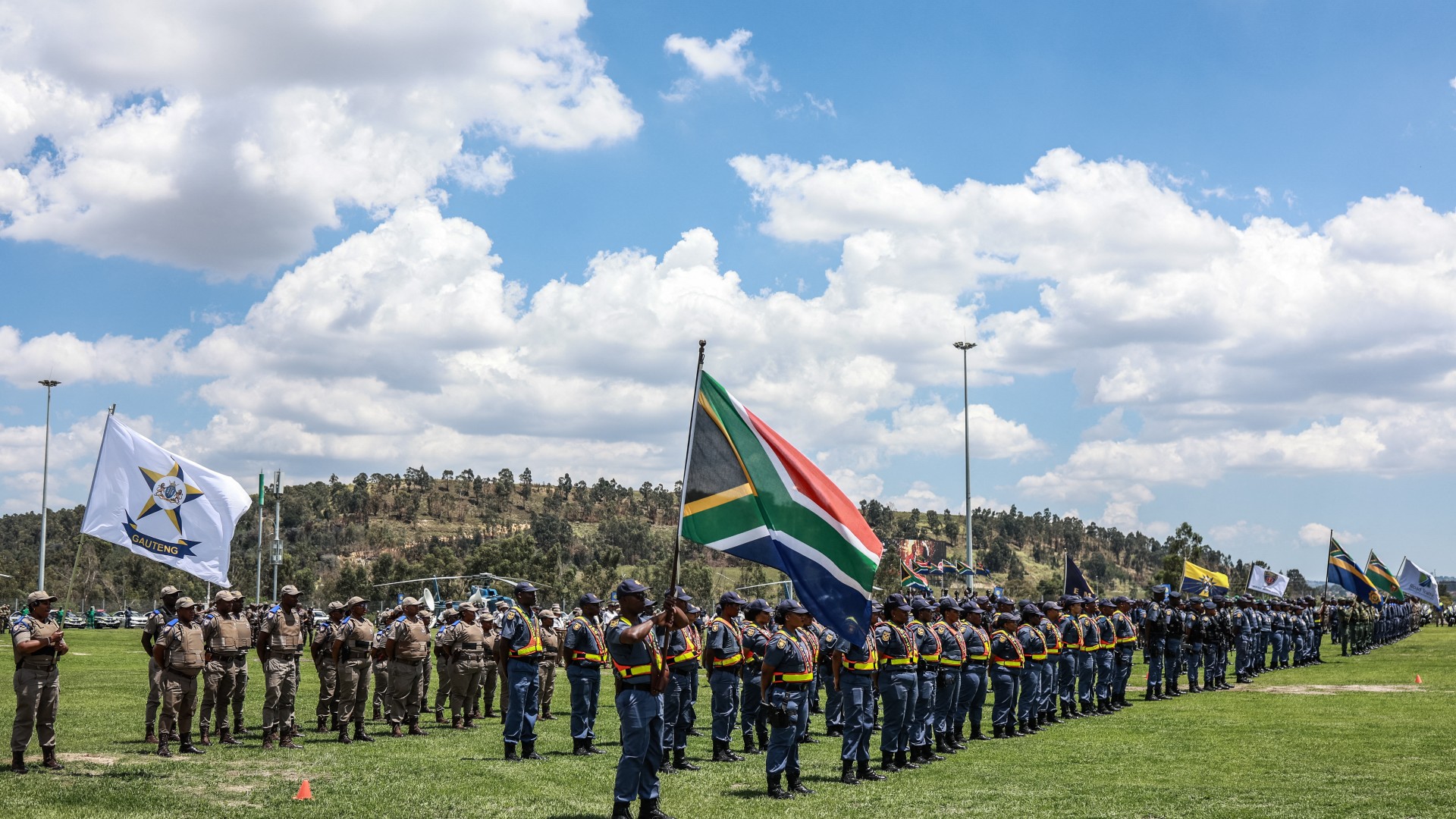 Members of the South African Police Service (SAPS) stand at attention during the Integrated Law Enforcement parade near the Nasrec Expo Centre in Johannesburg, on November 19, 2025.
