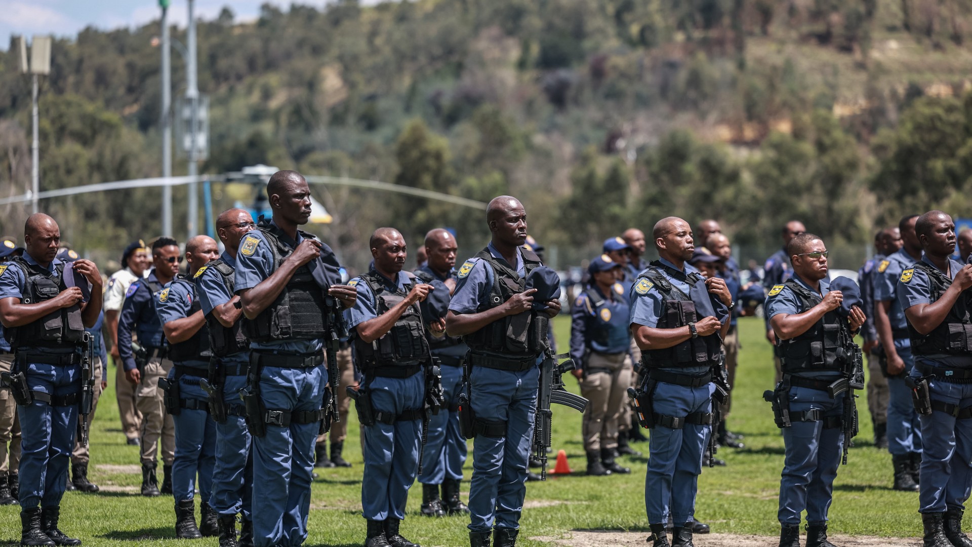 Members of the South African Police Service (SAPS) stand at attention during the Integrated Law Enforcement parade near the Nasrec Expo Centre in Johannesburg, on November 19, 2025.