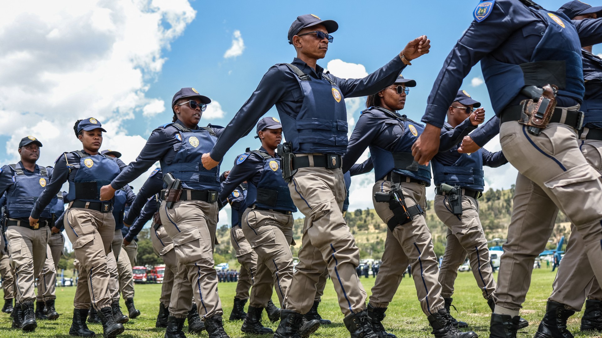 Members of the Johannesburg Metro Police Department (JMPD) march during the Integrated Law Enforcement parade near the Nasrec Expo Centre in Johannesburg, on November 19, 2025.