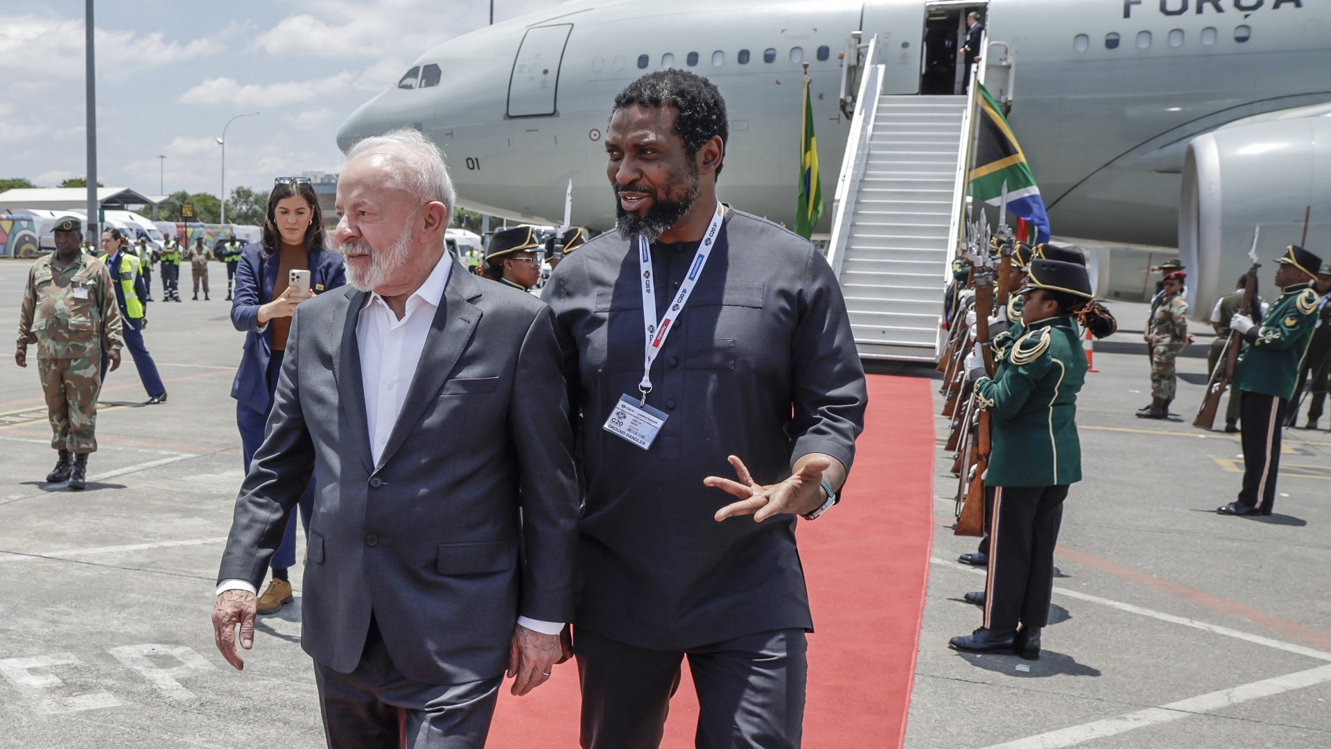 Brazil's President Luiz Inacio Lula da Silva (C-L) is welcomed by South Africa's Higher Education Minister Buti Manamela (C-R) upon his arrival at the OR Tambo International airport in Ekurhuleni on November 21, 2025 ahead of the G20 leader's Summit.