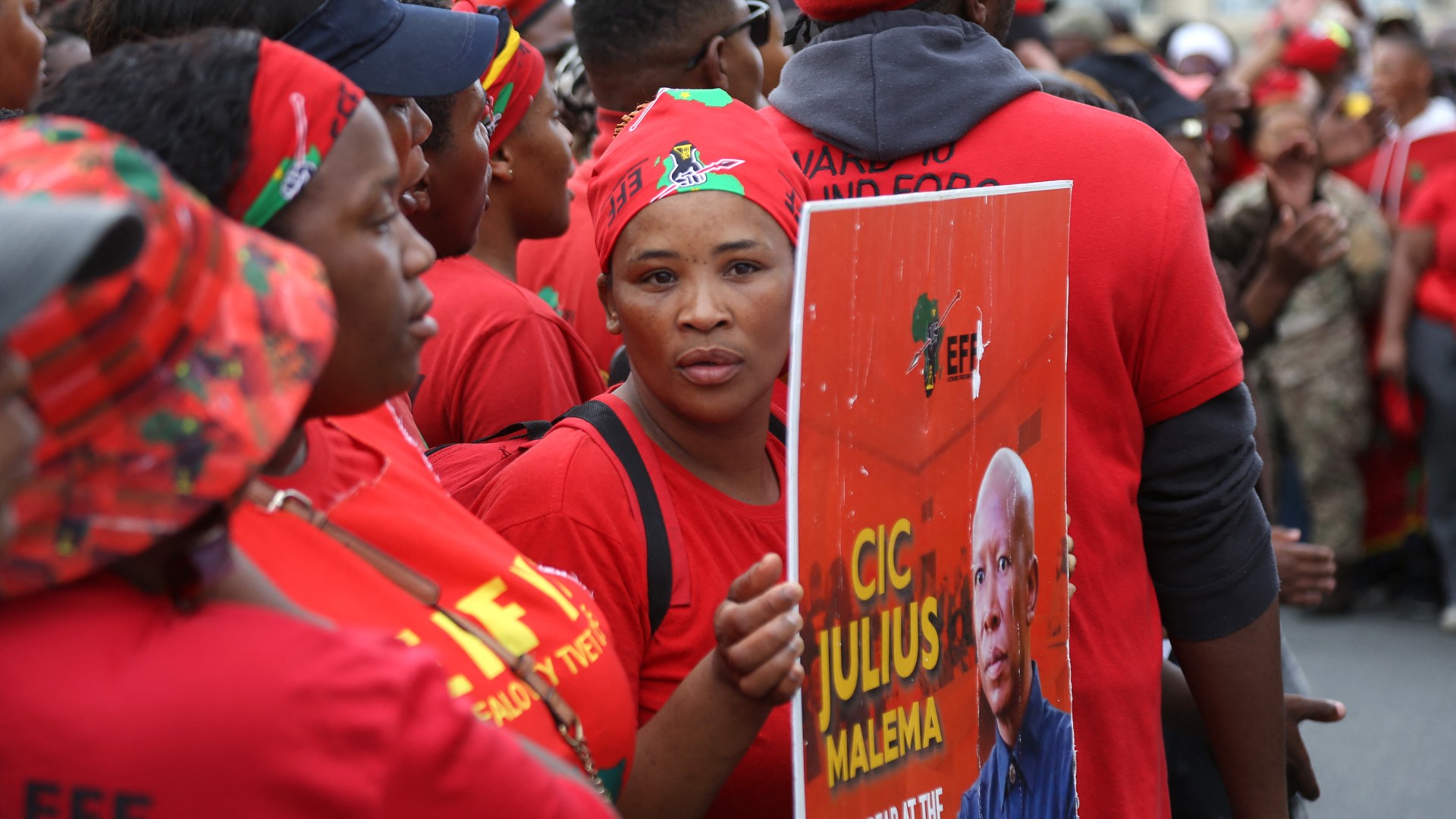 A supporter holds a placard of Economic Freedom Fighters (EFF) leader Julius Malema as they gather ahead of his arrival at the KuGompo City Regional court in East London on April 15, 2026 for his sentencing for firing an assault rifle at a rally eight years ago.