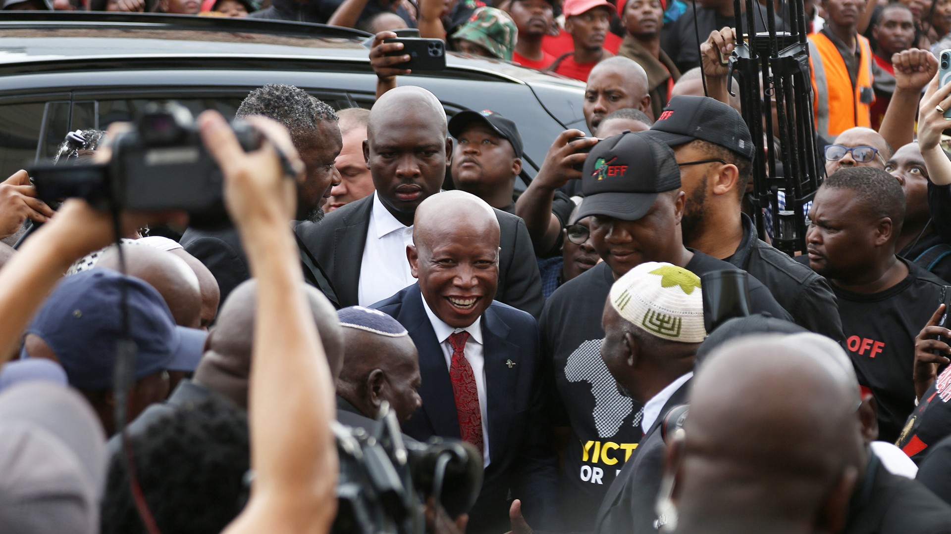 Economic Freedom Fighters (EFF) leader Julius Malema (C) arrives at the KuGompo City Regional court in East London on April 15, 2026 for his sentencing for firing an assault rifle at a rally eight years ago.