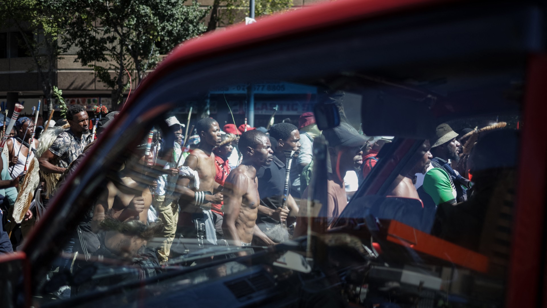 Protestors walk on a street during a protest march against undocumented migrants organised by “March and March” in Johannesburg on April 29, 2026.