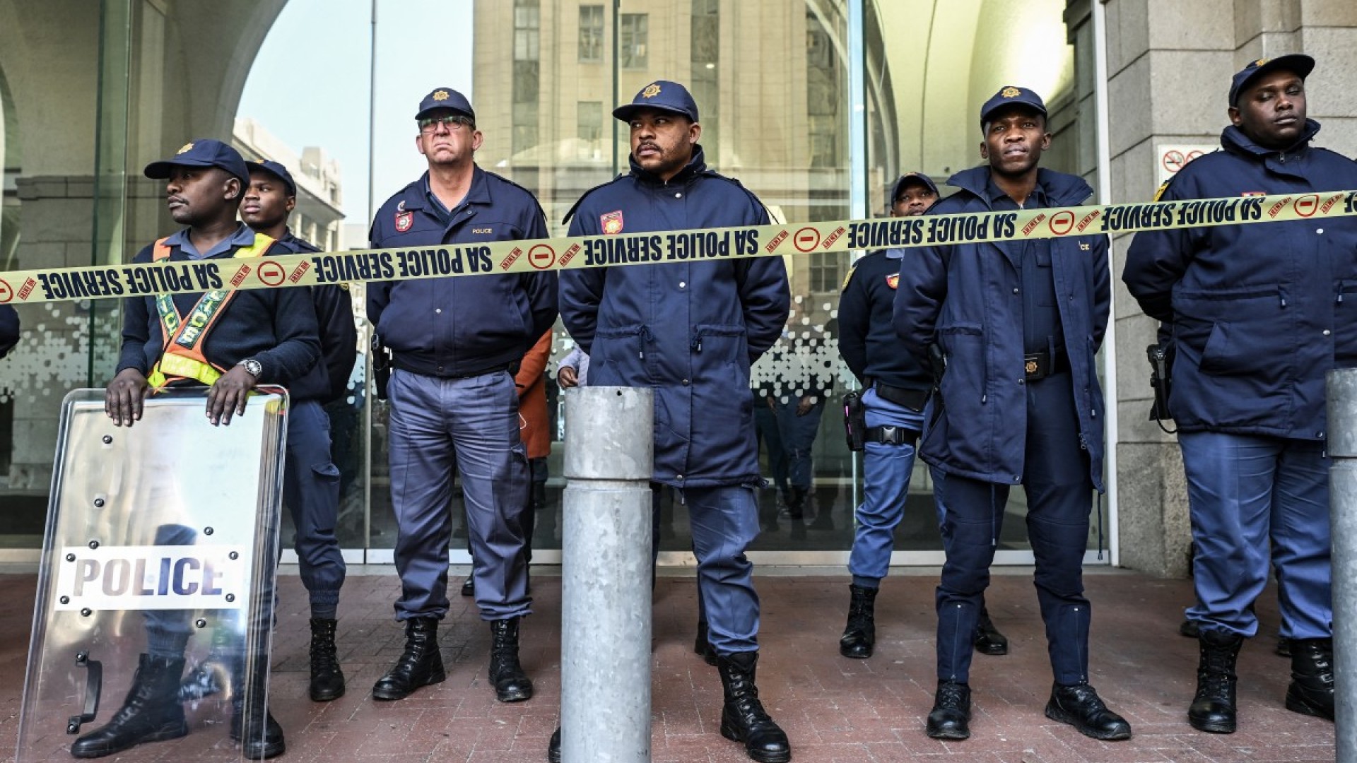 Members of the South African Police Service (SAPS) stand in formation as they monitor a demonstration by the "March and March" and Operation Dudula movements.  AFP/Rodger Bosch