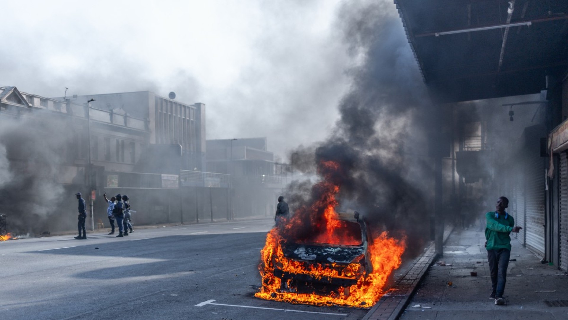 Police officers intervene as clashes erupt between protesters and foreign nationals in Durban. AFP/Rajesh Jantilal