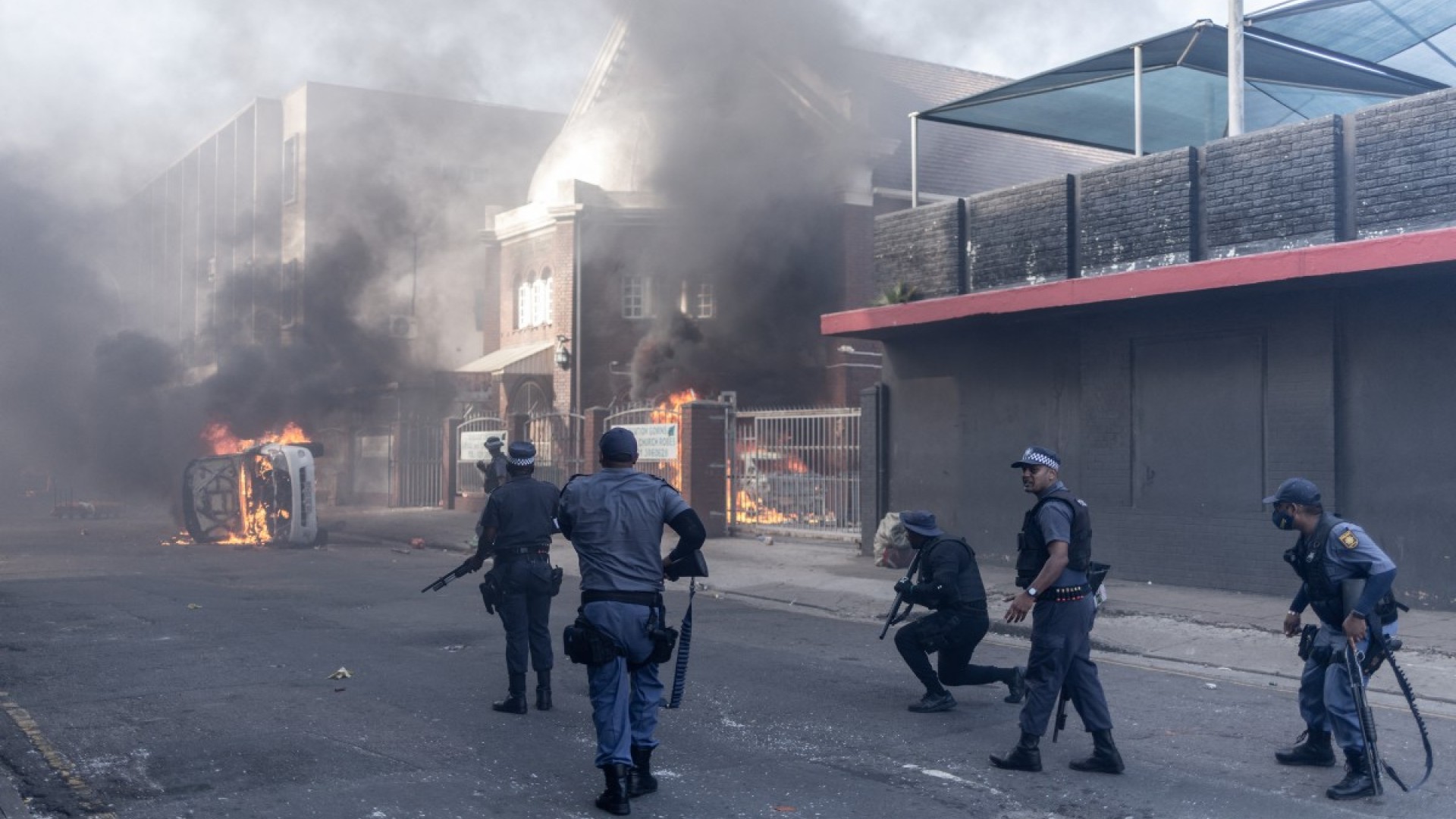 South African Police Service (SAPS) officers fire rubber bullets as clashes erupt between protesters and foreign nationals in Durban on October 8, 2026.