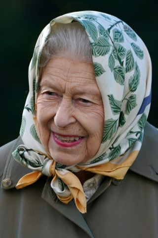 The queen was often seen wearing a headscarf, raincoat and boots during weekends at her country estates