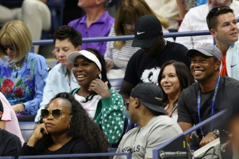 Super fan: Tiger Woods (right) watches the match with Venus Williams