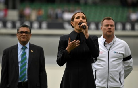 Laura Wright (C) sings ' God Save the King' at the Oval on Saturday