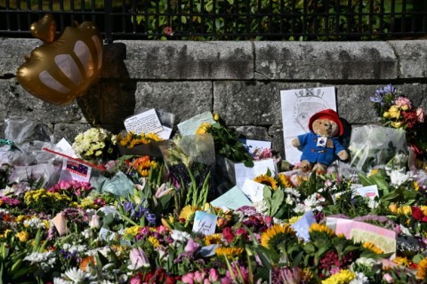 Floral tributes and a toy Paddington bear outside Balmoral Castle, the Scottish retreat where Queen Elizabeth II died