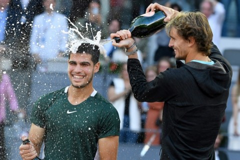 Champagne moment: Carlos Alcaraz (left) celebrates his Madrid Masters title triumph with  Alexander Zverev