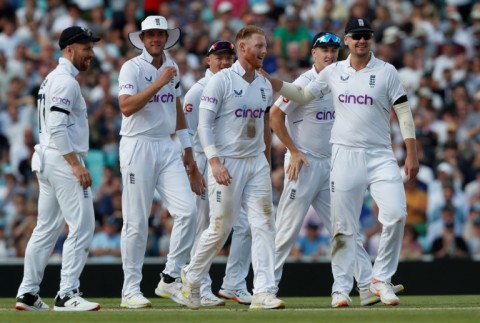 Leading from the front: England captain Ben Stokes (C) celebrates with teammates after he dismissed South Africa's Marco Jansen
