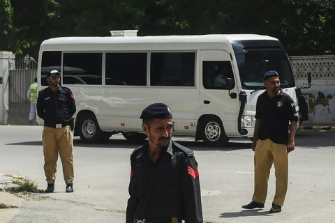 An England team bus drives past security in Karachi after their arrival for their first tour in 17 years